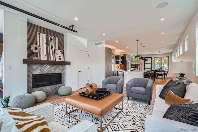 4474 Utica St, Denver, CO 80212 - living area featuring light wood-style floors, recessed lighting, and a tile fireplace