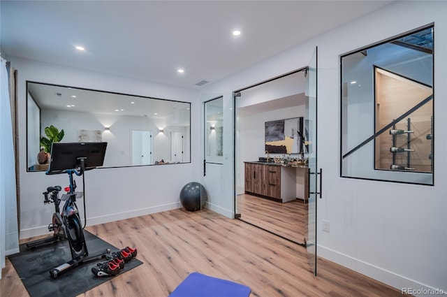 4474 Utica St, Denver, CO 80212 - workout area with wood finished floors and recessed lighting