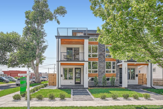 4474 Utica St, Denver, CO 80212 - contemporary home featuring a balcony and stone siding