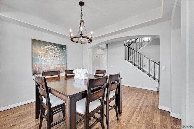 dining room featuring hardwood / wood-style flooring and a chandelier