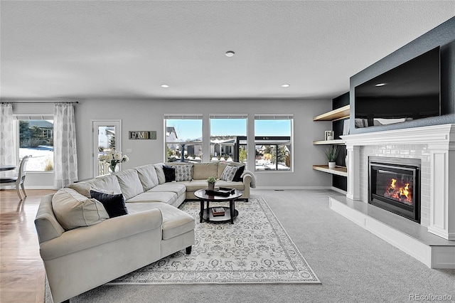 living room with light colored carpet, plenty of natural light, and a textured ceiling