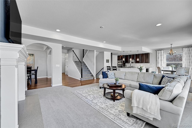 living room featuring a textured ceiling and a notable chandelier