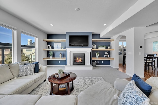 living room featuring hardwood / wood-style floors and built in shelves