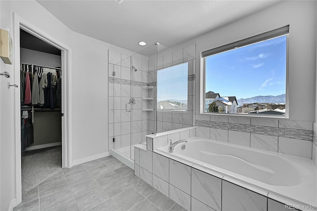 bathroom with separate shower and tub and a mountain view