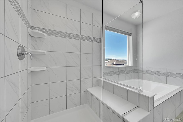 bathroom with a relaxing tiled tub