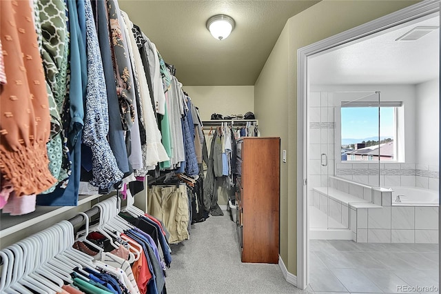 spacious closet with light tile patterned floors