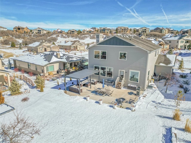 snow covered house with a patio