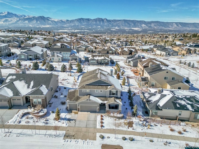 snowy aerial view with a mountain view