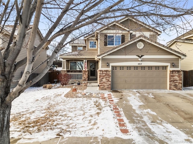 craftsman-style house featuring a garage, concrete driveway, brick siding, and covered porch