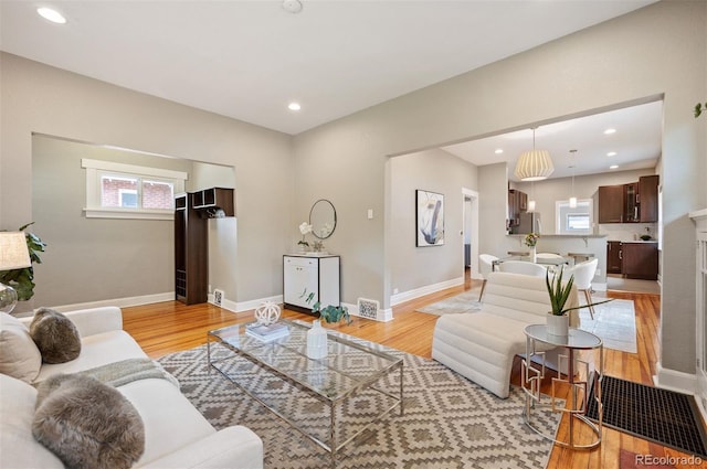 1532 Meade St, Denver, CO 80204 - living room featuring light wood-type flooring, baseboards, and recessed lighting