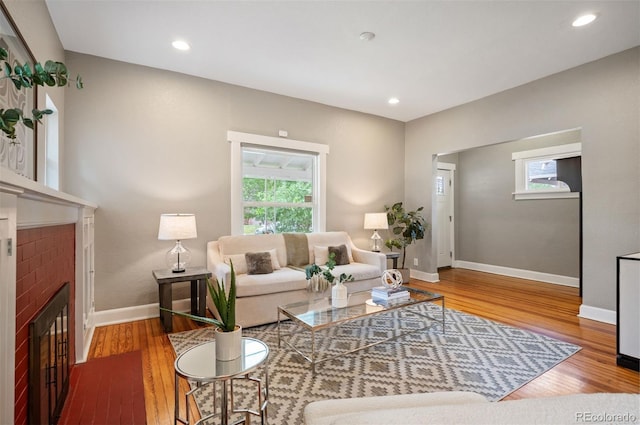 1532 Meade St, Denver, CO 80204 - living area with a fireplace, plenty of natural light, baseboards, wood finished floors, and recessed lighting