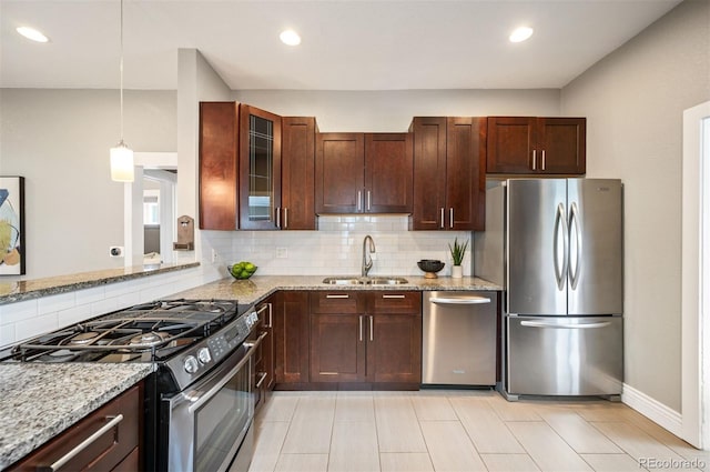 1532 Meade St, Denver, CO 80204 - kitchen featuring stainless steel appliances, a sink, decorative backsplash, light stone counters, and glass insert cabinets