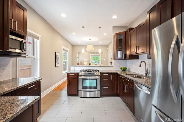 1532 Meade St, Denver, CO 80204 - kitchen with appliances with stainless steel finishes, a sink, decorative backsplash, a peninsula, and glass insert cabinets