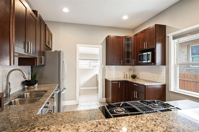 1532 Meade St, Denver, CO 80204 - kitchen featuring a sink, stovetop with downdraft, stainless steel microwave, glass insert cabinets, and baseboards