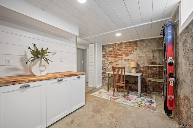 1532 Meade St, Denver, CO 80204 - dining room with unfinished concrete flooring, brick wall, and recessed lighting