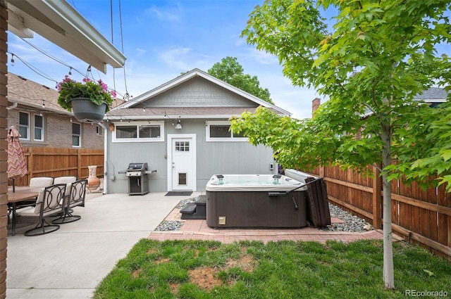 1532 Meade St, Denver, CO 80204 - back of house with a hot tub, a fenced backyard, and a patio