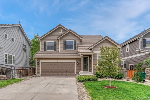 view of front of house featuring a tiled roof, concrete driveway, and an attached garage