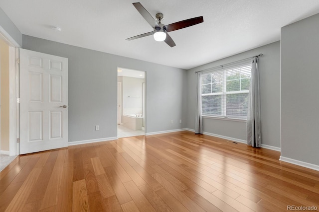 unfurnished bedroom with light wood-style flooring, baseboards, and ceiling fan