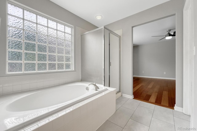 bathroom featuring a garden tub, a stall shower, a ceiling fan, and tile patterned floors
