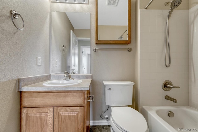 bathroom featuring a textured wall, toilet, shower / tub combination, and vanity