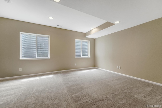 carpeted empty room with baseboards and recessed lighting