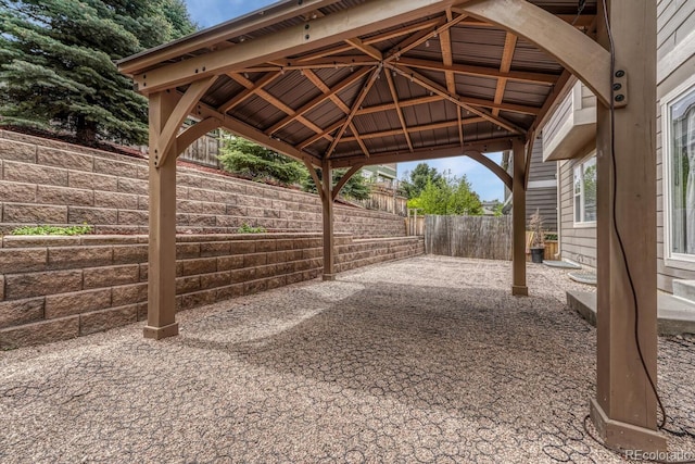 view of patio with a fenced backyard, a gazebo, and a carport
