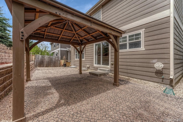 view of patio featuring fence and a gazebo