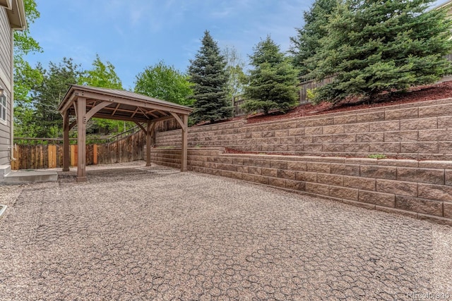 view of parking / parking lot with a gazebo and a fenced backyard