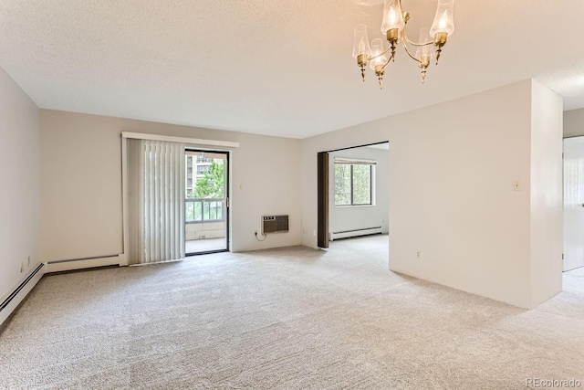 spare room featuring light colored carpet, a baseboard radiator, and a textured ceiling