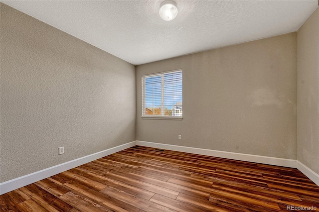 unfurnished room with wood-type flooring