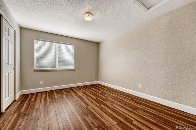 unfurnished bedroom with hardwood / wood-style floors and a textured ceiling