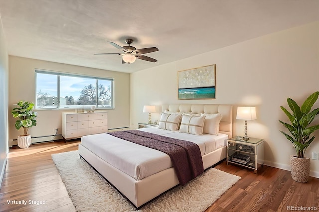 9335 E Center Ave Unit 7B, Denver, CO 80247 - bedroom featuring wood finished floors, a baseboard heating unit, ceiling fan, and baseboard heating