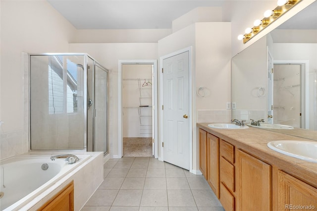 274 W Willowick Cir, Highlands Ranch, CO 80129 - bathroom with a spacious closet, a stall shower, double vanity, a bath, and tile patterned flooring