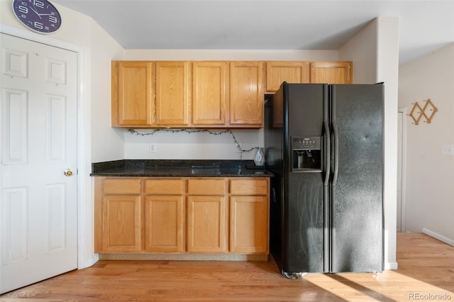 274 W Willowick Cir, Highlands Ranch, CO 80129 - kitchen featuring black refrigerator with ice dispenser, light wood-style flooring, and dark stone counters