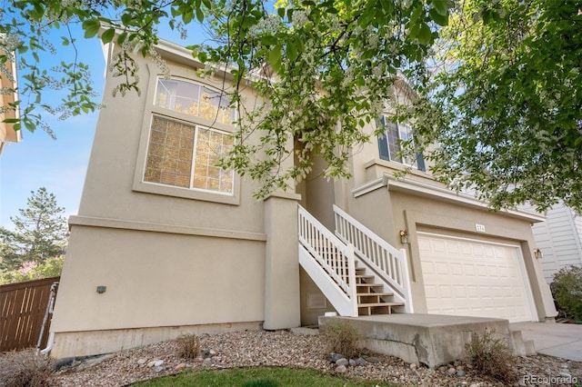 274 W Willowick Cir, Highlands Ranch, CO 80129 - view of front facade with stucco siding, stairway, and concrete driveway