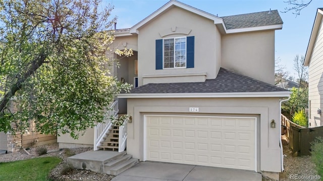 274 W Willowick Cir, Highlands Ranch, CO 80129 - view of front of home featuring stairway, a shingled roof, driveway, and a garage