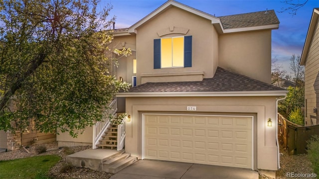274 W Willowick Cir, Highlands Ranch, CO 80129 - view of front of house featuring stairs, a shingled roof, stucco siding, and driveway