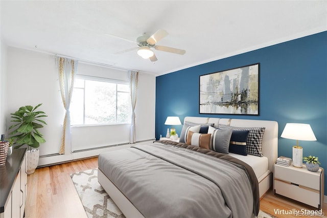 bedroom with light wood-type flooring, a baseboard radiator, ceiling fan, and crown molding