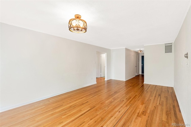 unfurnished room featuring visible vents, baseboards, and light wood-style floors