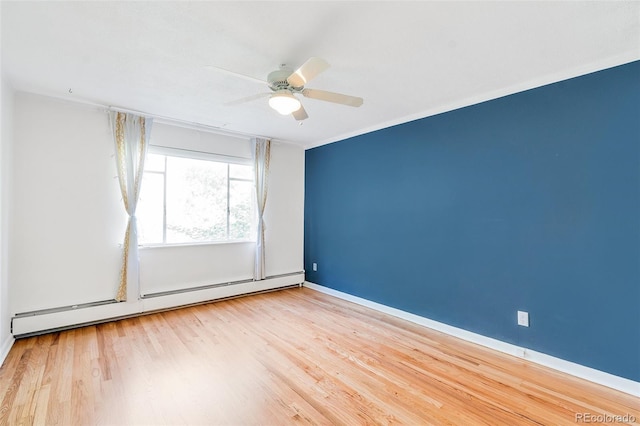 spare room featuring ceiling fan, wood finished floors, baseboards, and a baseboard radiator