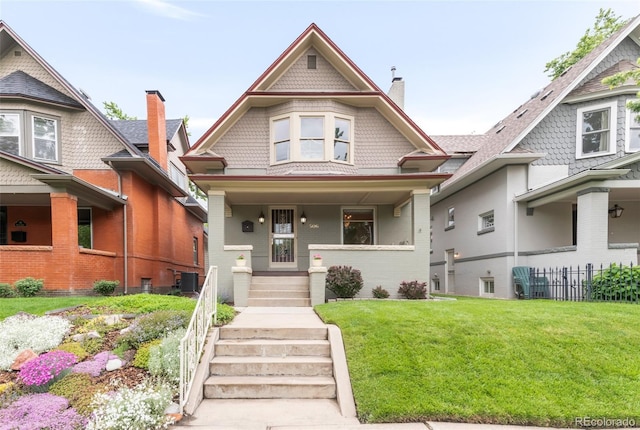 506 N Marion St, Denver, CO 80218 - victorian house featuring a chimney, a front lawn, cooling unit, covered porch, and brick siding