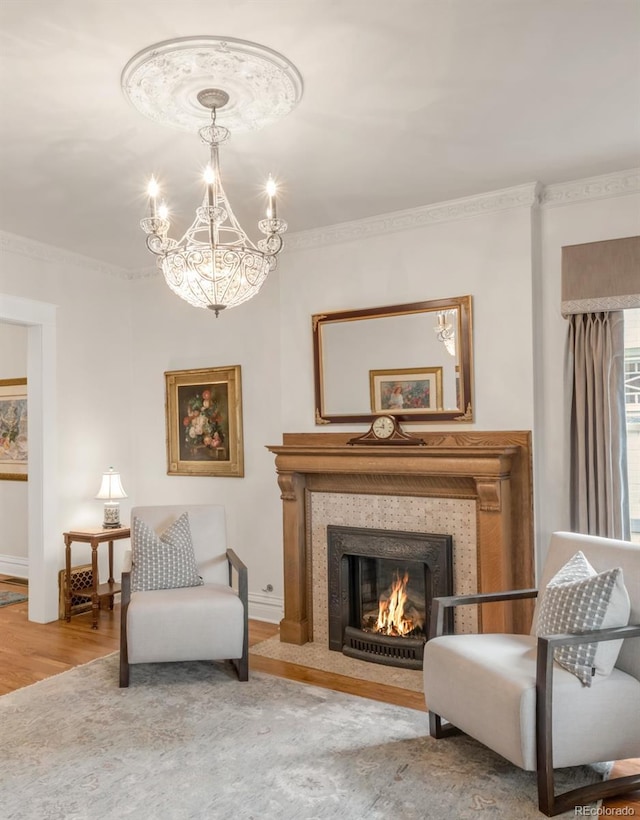 506 N Marion St, Denver, CO 80218 - living area featuring ornamental molding, a chandelier, baseboards, wood finished floors, and a tile fireplace