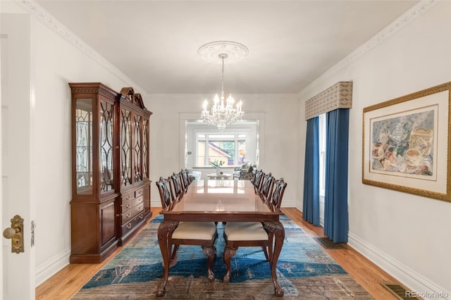 506 N Marion St, Denver, CO 80218 - dining room with a chandelier, light wood finished floors, baseboards, and ornamental molding