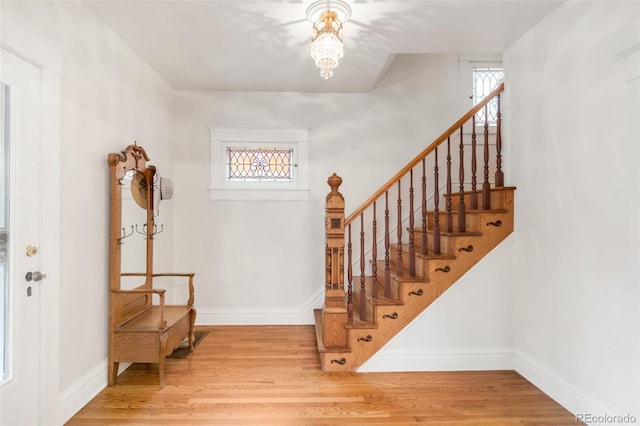506 N Marion St, Denver, CO 80218 - foyer with stairway, wood finished floors, baseboards, and a chandelier