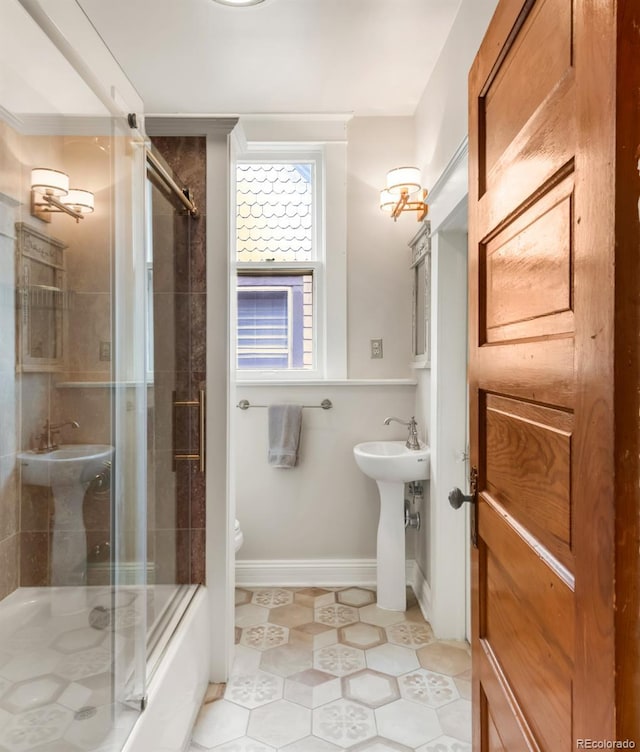 506 N Marion St, Denver, CO 80218 - bathroom featuring toilet, tile patterned floors, baseboards, and enclosed tub / shower combo