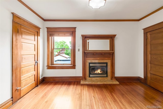 506 N Marion St, Denver, CO 80218 - unfurnished living room featuring baseboards, light wood finished floors, a glass covered fireplace, and ornamental molding