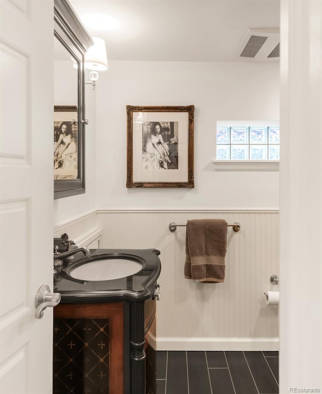 506 N Marion St, Denver, CO 80218 - bathroom with vanity, a wainscoted wall, and tile patterned floors