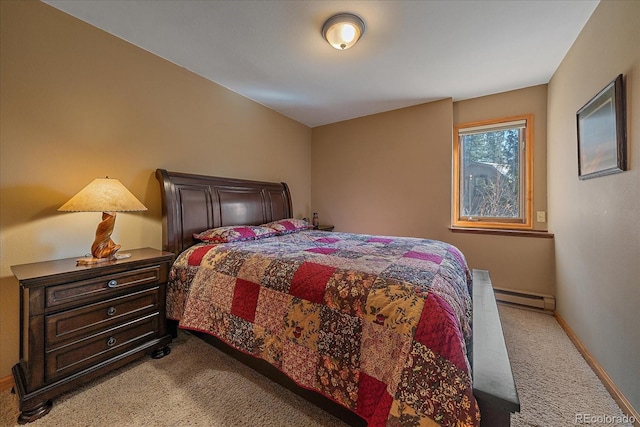 carpeted bedroom with a baseboard heating unit and baseboards