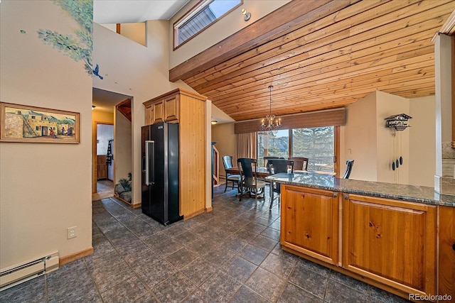 kitchen featuring brown cabinetry, wooden ceiling, a baseboard radiator, high end black refrigerator, and a notable chandelier