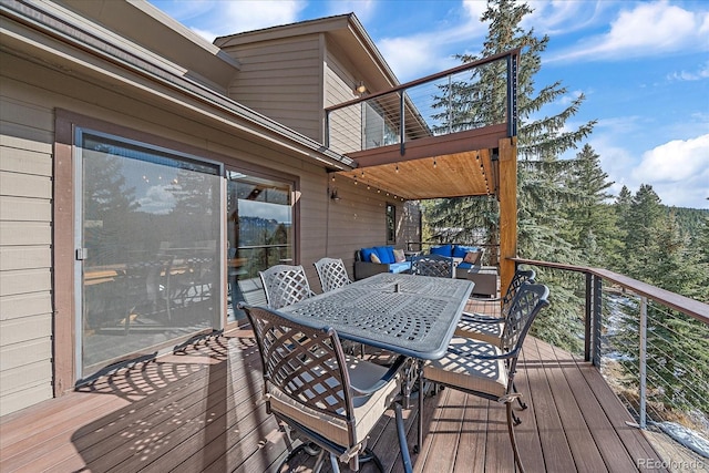 wooden terrace with outdoor dining space